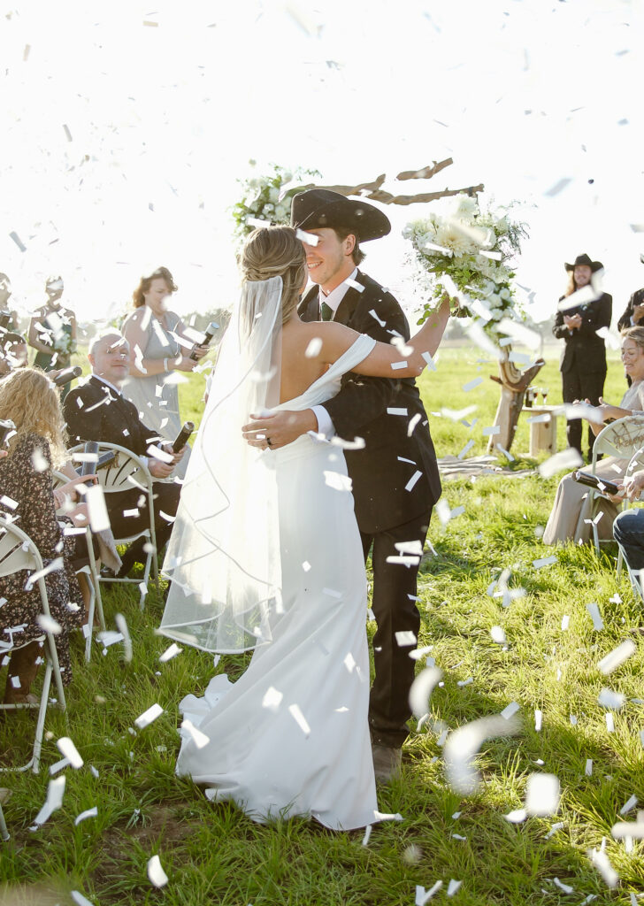 Confetti surrounding the newly wedded couple at their western wedding.